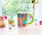 Care Bears Allover Print Ceramic Mug With Rainbow Handle | Holds 20 Ounces